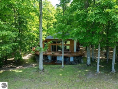 Tucked away in a private setting with frontage on the 13th hole on Schuss Mountain Golf Club in Michigan - for sale on GolfHomes.com, golf home, golf lot