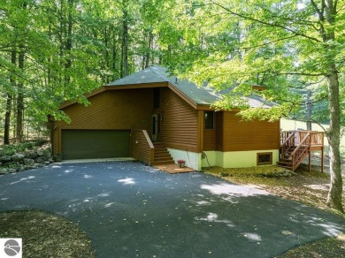 Tucked away in a private setting with frontage on the 13th hole on Schuss Mountain Golf Club in Michigan - for sale on GolfHomes.com, golf home, golf lot