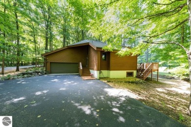 Tucked away in a private setting with frontage on the 13th hole on Schuss Mountain Golf Club in Michigan - for sale on GolfHomes.com, golf home, golf lot