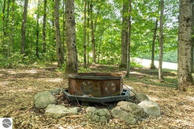 Tucked away in a private setting with frontage on the 13th hole on Schuss Mountain Golf Club in Michigan - for sale on GolfHomes.com, golf home, golf lot