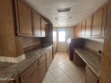 Investor special with incredible lake, mountain, and golf course on London Bridge Golf Course in Arizona - for sale on GolfHomes.com, golf home, golf lot