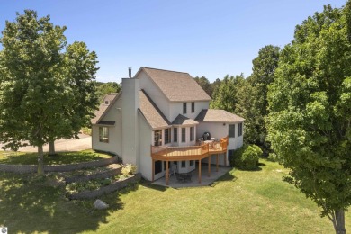 Perched on a quiet hilltop with sweeping views of Bear Lake and on  in Michigan - for sale on GolfHomes.com, golf home, golf lot