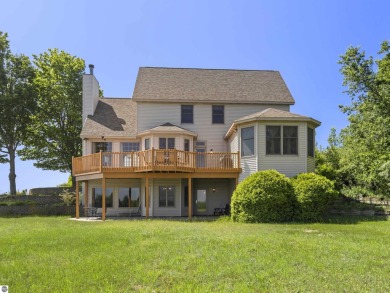 Perched on a quiet hilltop with sweeping views of Bear Lake and on  in Michigan - for sale on GolfHomes.com, golf home, golf lot