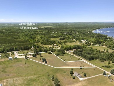Perched on a quiet hilltop with sweeping views of Bear Lake and on  in Michigan - for sale on GolfHomes.com, golf home, golf lot