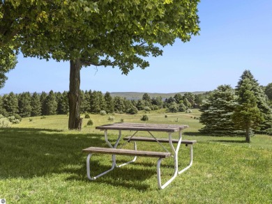 Perched on a quiet hilltop with sweeping views of Bear Lake and on  in Michigan - for sale on GolfHomes.com, golf home, golf lot