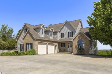Perched on a quiet hilltop with sweeping views of Bear Lake and on  in Michigan - for sale on GolfHomes.com, golf home, golf lot