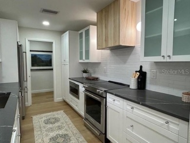 Experience the best of Dunedin living in this meticulously on The Dunedin Country Club in Florida - for sale on GolfHomes.com, golf home, golf lot