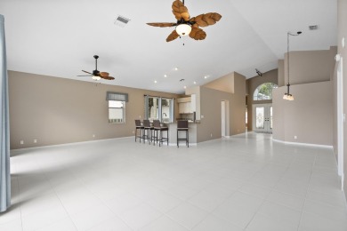 Soak in serene lake views with a backdrop of the golf course in on Santa Lucia River Club in Florida - for sale on GolfHomes.com, golf home, golf lot
