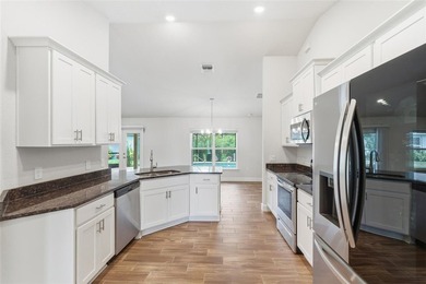 Beautifully maintained 4-bedroom, 2-bath pool home situated on a on Deep Creek Golf Club in Florida - for sale on GolfHomes.com, golf home, golf lot