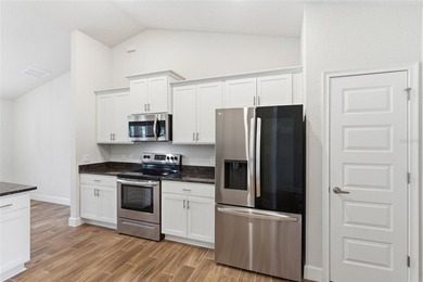 Beautifully maintained 4-bedroom, 2-bath pool home situated on a on Deep Creek Golf Club in Florida - for sale on GolfHomes.com, golf home, golf lot