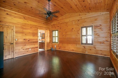 Discover this exceptional 1.5-story log home nestled in a on Lake Louise Golf Club in North Carolina - for sale on GolfHomes.com, golf home, golf lot