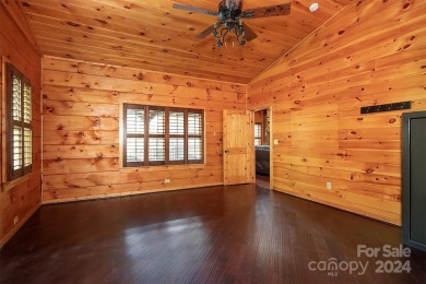 Discover this exceptional 1.5-story log home nestled in a on Lake Louise Golf Club in North Carolina - for sale on GolfHomes.com, golf home, golf lot