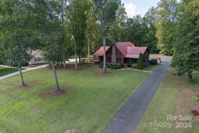 Discover this exceptional 1.5-story log home nestled in a on Lake Louise Golf Club in North Carolina - for sale on GolfHomes.com, golf home, golf lot