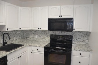Experience serenity in this stunning 1-bedroom, 1-bathroom on Jacaranda Golf Club in Florida - for sale on GolfHomes.com, golf home, golf lot
