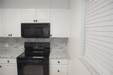 Experience serenity in this stunning 1-bedroom, 1-bathroom on Jacaranda Golf Club in Florida - for sale on GolfHomes.com, golf home, golf lot