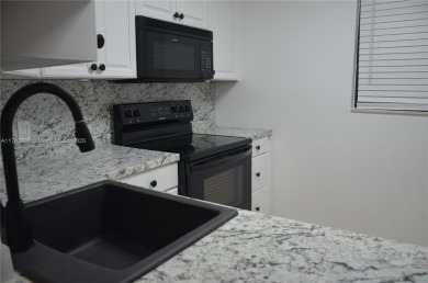 Experience serenity in this stunning 1-bedroom, 1-bathroom on Jacaranda Golf Club in Florida - for sale on GolfHomes.com, golf home, golf lot