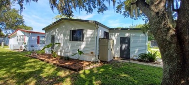 Come settle down and relax in a beautiful, manufactured home on Fairways Country Club in Florida - for sale on GolfHomes.com, golf home, golf lot