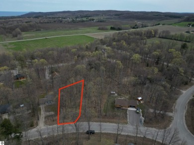 Surrounded by the natural beauty of mature hardwoods and on Manitou Passage Golf Club in Michigan - for sale on GolfHomes.com, golf home, golf lot