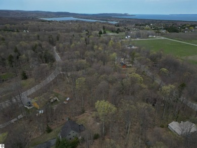 Surrounded by the natural beauty of mature hardwoods and on Manitou Passage Golf Club in Michigan - for sale on GolfHomes.com, golf home, golf lot