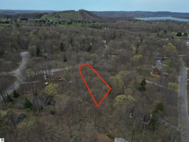 Surrounded by the natural beauty of mature hardwoods and on Manitou Passage Golf Club in Michigan - for sale on GolfHomes.com, golf home, golf lot