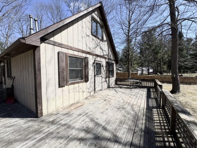 This charming 3-bedroom, 1-bath chalet-style home offers a on Birch Pointe Golf Club in Michigan - for sale on GolfHomes.com, golf home, golf lot