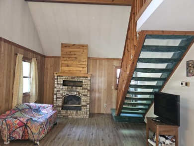 This charming 3-bedroom, 1-bath chalet-style home offers a on Birch Pointe Golf Club in Michigan - for sale on GolfHomes.com, golf home, golf lot