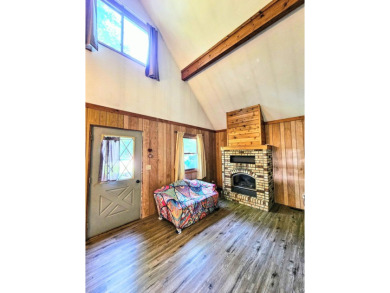 This charming 3-bedroom, 1-bath chalet-style home offers a on Birch Pointe Golf Club in Michigan - for sale on GolfHomes.com, golf home, golf lot