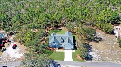 Cradled by the gentle currents where the Shallotte River meets on Lockwood Folly Country Club in North Carolina - for sale on GolfHomes.com, golf home, golf lot