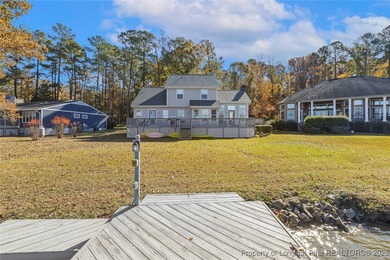 Waterfront home with stunning views located in the gated and on Carolina Trace Country Club in North Carolina - for sale on GolfHomes.com, golf home, golf lot