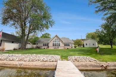 Welcome to 1171 North Shore, an exceptional waterfront property on Duck Lake Country Club in Michigan - for sale on GolfHomes.com, golf home, golf lot