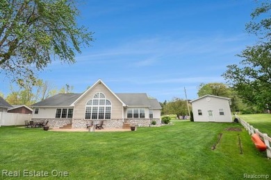 Welcome to 1171 North Shore, an exceptional waterfront property on Duck Lake Country Club in Michigan - for sale on GolfHomes.com, golf home, golf lot