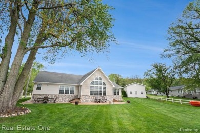 Welcome to 1171 North Shore, an exceptional waterfront property on Duck Lake Country Club in Michigan - for sale on GolfHomes.com, golf home, golf lot