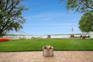 Welcome to 1171 North Shore, an exceptional waterfront property on Duck Lake Country Club in Michigan - for sale on GolfHomes.com, golf home, golf lot