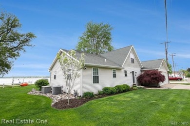 Welcome to 1171 North Shore, an exceptional waterfront property on Duck Lake Country Club in Michigan - for sale on GolfHomes.com, golf home, golf lot