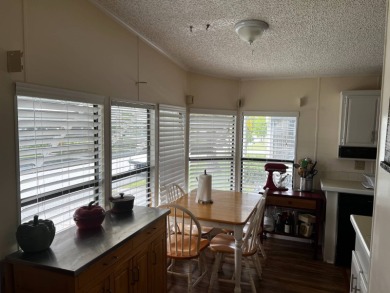 Community living in a great location with tons of activities in on Lake Henry Golf Club in Florida - for sale on GolfHomes.com, golf home, golf lot