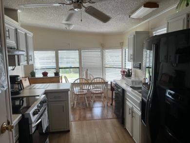 Community living in a great location with tons of activities in on Lake Henry Golf Club in Florida - for sale on GolfHomes.com, golf home, golf lot