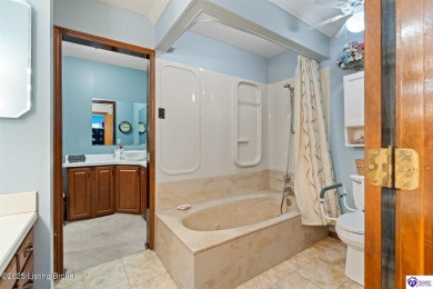 Experience tranquility and comfort in Brandenburg's premier on Doe Valley Country Club in Kentucky - for sale on GolfHomes.com, golf home, golf lot