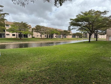Enjoy the peace and quiet lake view from this bright ground on Sunrise Lakes Phase IV Golf Course in Florida - for sale on GolfHomes.com, golf home, golf lot