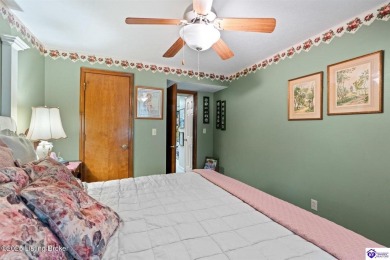 Experience tranquility and comfort in Brandenburg's premier on Doe Valley Country Club in Kentucky - for sale on GolfHomes.com, golf home, golf lot