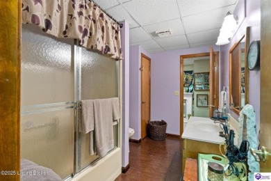 Experience tranquility and comfort in Brandenburg's premier on Doe Valley Country Club in Kentucky - for sale on GolfHomes.com, golf home, golf lot
