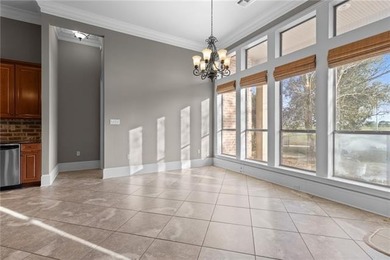 Enjoy serene water and golf course views from this exceptional on Oak Harbor Golf Club in Louisiana - for sale on GolfHomes.com, golf home, golf lot