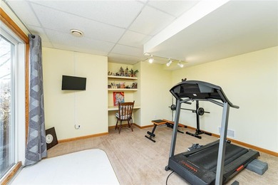 This 3-bed, 4-bath home on a full acre corner lot will not on Zumbro Valley Golf Club in Minnesota - for sale on GolfHomes.com, golf home, golf lot