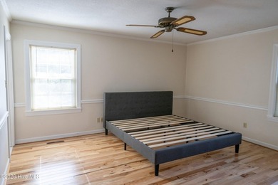 Discover a sanctuary of quiet elegance at 614 Lake Shore Drive on Walnut Creek Country Club in North Carolina - for sale on GolfHomes.com, golf home, golf lot