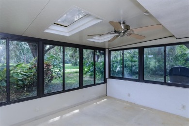 Tucked beneath the shade of moss-draped oaks and overlooking on Tarpon Woods Golf Club in Florida - for sale on GolfHomes.com, golf home, golf lot