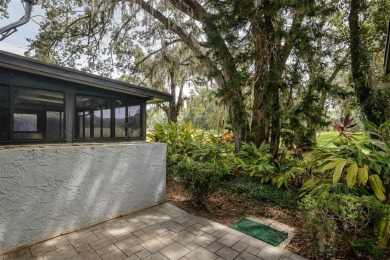 Tucked beneath the shade of moss-draped oaks and overlooking on Tarpon Woods Golf Club in Florida - for sale on GolfHomes.com, golf home, golf lot