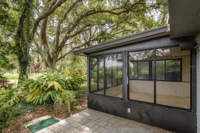 Tucked beneath the shade of moss-draped oaks and overlooking on Tarpon Woods Golf Club in Florida - for sale on GolfHomes.com, golf home, golf lot