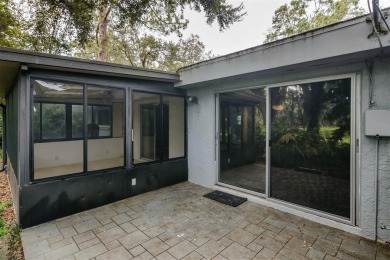 Tucked beneath the shade of moss-draped oaks and overlooking on Tarpon Woods Golf Club in Florida - for sale on GolfHomes.com, golf home, golf lot