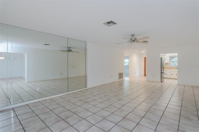 Tucked beneath the shade of moss-draped oaks and overlooking on Tarpon Woods Golf Club in Florida - for sale on GolfHomes.com, golf home, golf lot