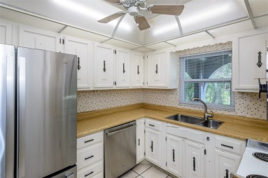 Tucked beneath the shade of moss-draped oaks and overlooking on Tarpon Woods Golf Club in Florida - for sale on GolfHomes.com, golf home, golf lot