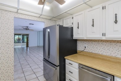 Tucked beneath the shade of moss-draped oaks and overlooking on Tarpon Woods Golf Club in Florida - for sale on GolfHomes.com, golf home, golf lot
